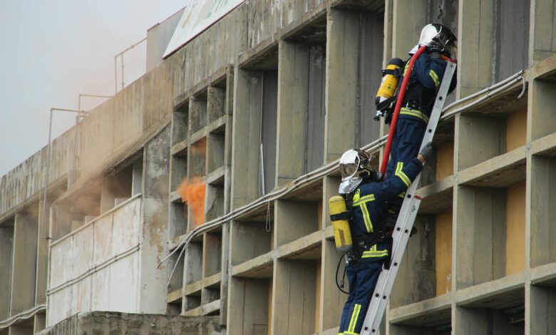 Firefighters on a Metal Ladder