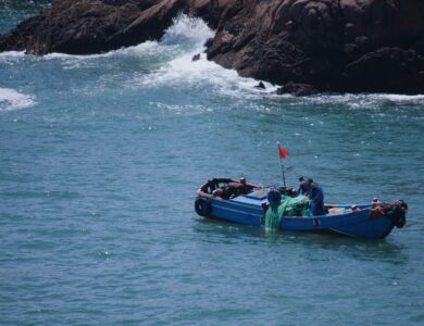 A small boat in the ocean with a man in it