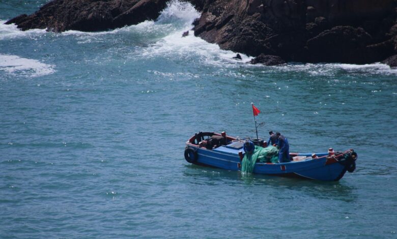 A small boat in the ocean with a man in it