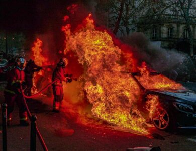 Firefighters Extinguishing a Burning Car