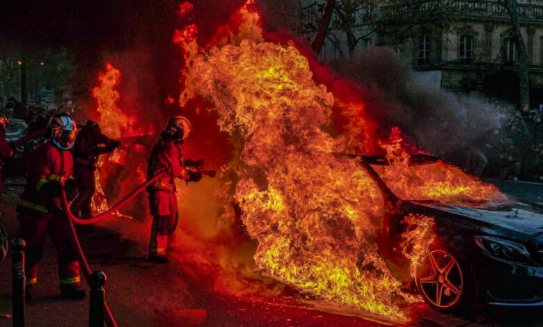 Firefighters Extinguishing a Burning Car