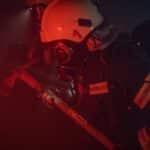 Photo of a Firefighter with a Helmet Holding an Axe