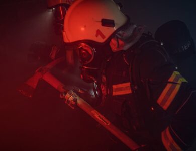 Photo of a Firefighter with a Helmet Holding an Axe