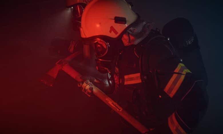 Photo of a Firefighter with a Helmet Holding an Axe