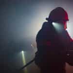 Photo of a Firefighter Holding a Hose