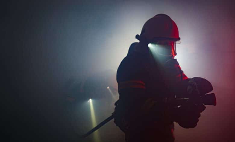Photo of a Firefighter Holding a Hose