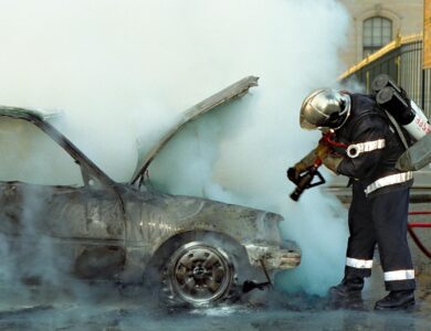 A Firefighter Extinguishing a Broken Car