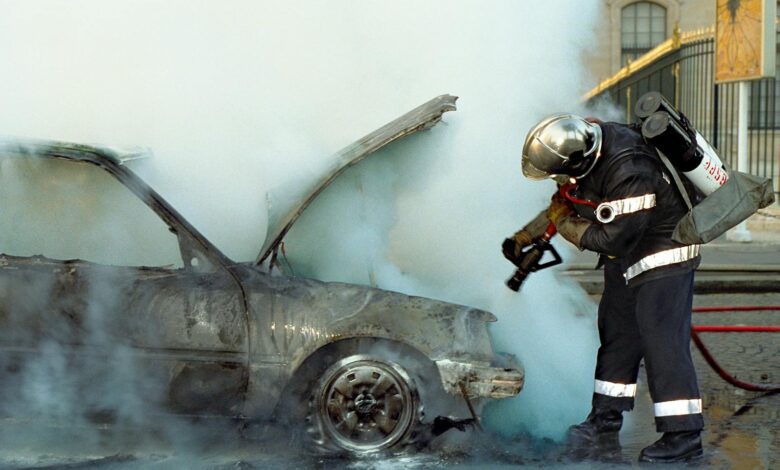 A Firefighter Extinguishing a Broken Car