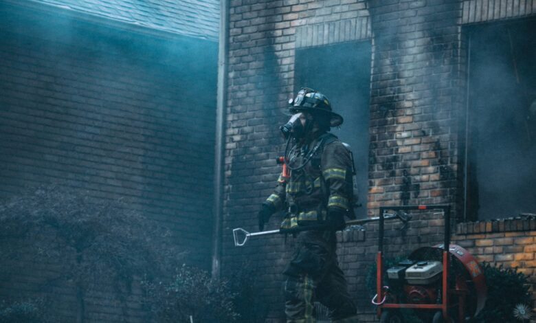 fireman holding rod near building at daytime