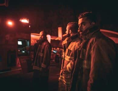three fire fighters looking back