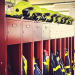 a row of lockers with helmets on top of them