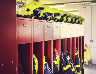 a row of lockers with helmets on top of them